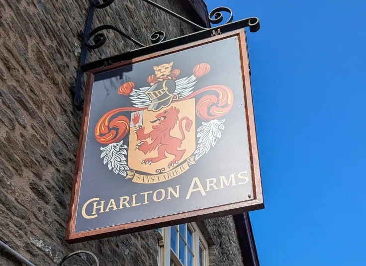 The actual arms consist of a red rampant lion facing west on a yellow coat of arms